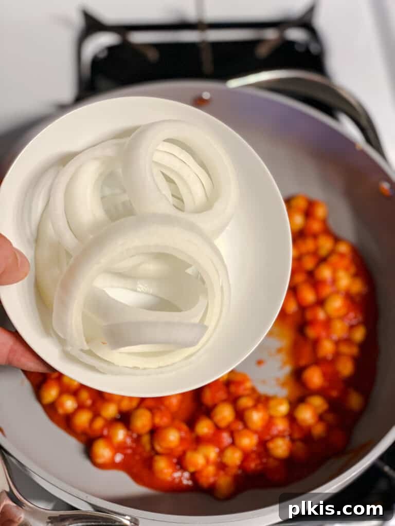 Creamy Tandoori Chickpea Curry Vegan 8 process shot of adding spices to pan