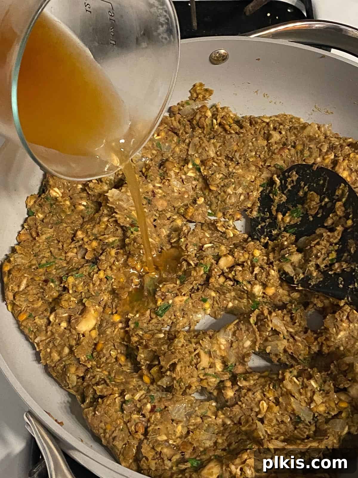Mighty Lentil Meatballs 12 process shot of adding veggie broth to pan