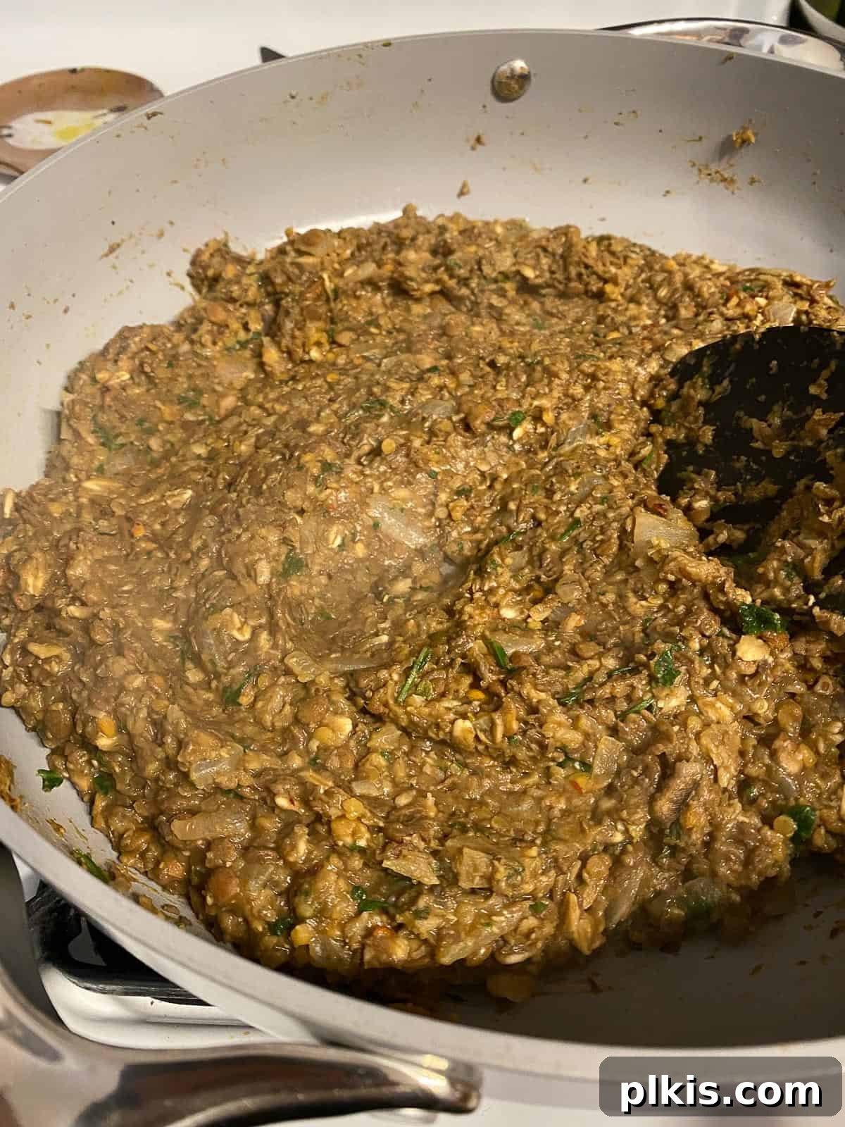 Mighty Lentil Meatballs 14 process shot of mixing lentil meatball mixture in pan