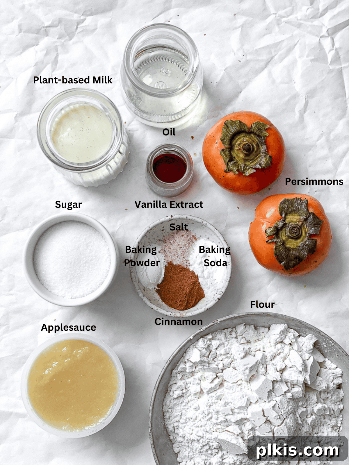 process shot showing ingredients for Easy Persimmon Bread on a white surface