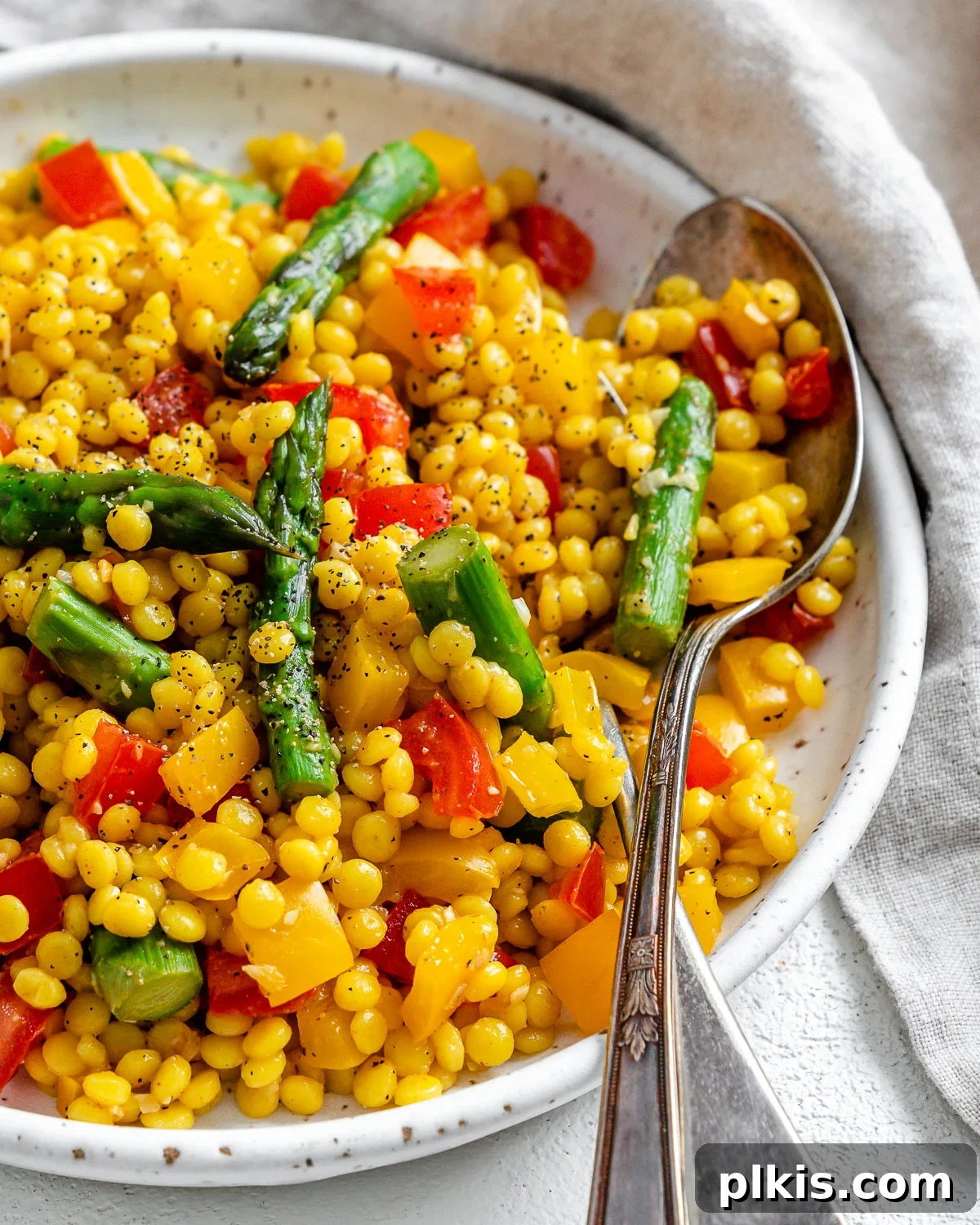 Vibrant Vegan Couscous with Fresh Vegetables 8 Completed Vegetable Couscous in a white plate against a white surface, ready to be enjoyed