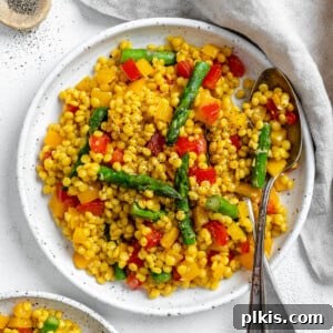 Vibrant Vegan Couscous with Fresh Vegetables 9 completed Vegetable Couscous in a white plate against a white surface