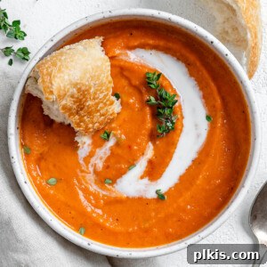 Velvety Vegan Tomato Thyme Bisque 8 completed Vegan Tomato Bisque with Thyme in a white bowl against a light background