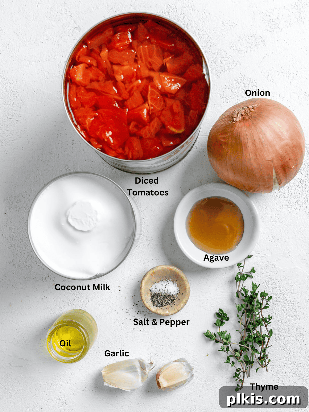 Velvety Vegan Tomato Thyme Bisque 3 Ingredients for Tomato Bisque measured out on a white surface.