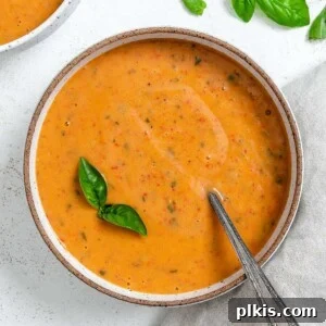 Velvety Roasted Red Pepper Soup 10 completed Creamy Roasted Red Pepper Soup in a bowl against a light surface