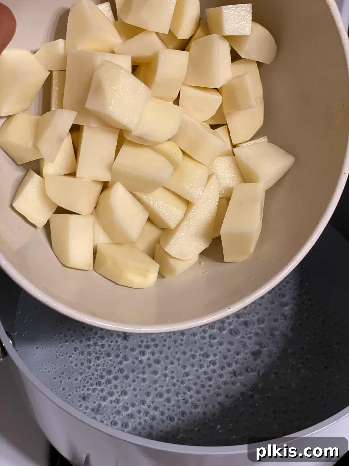 Velvety Roasted Red Pepper Soup 4 Cubed russet potatoes ready for cooking, next to a large pot.