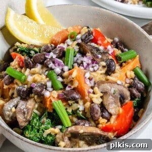 A plated bowl of delicious black bean and onion pilaf, highlighting the key ingredients and appealing presentation.