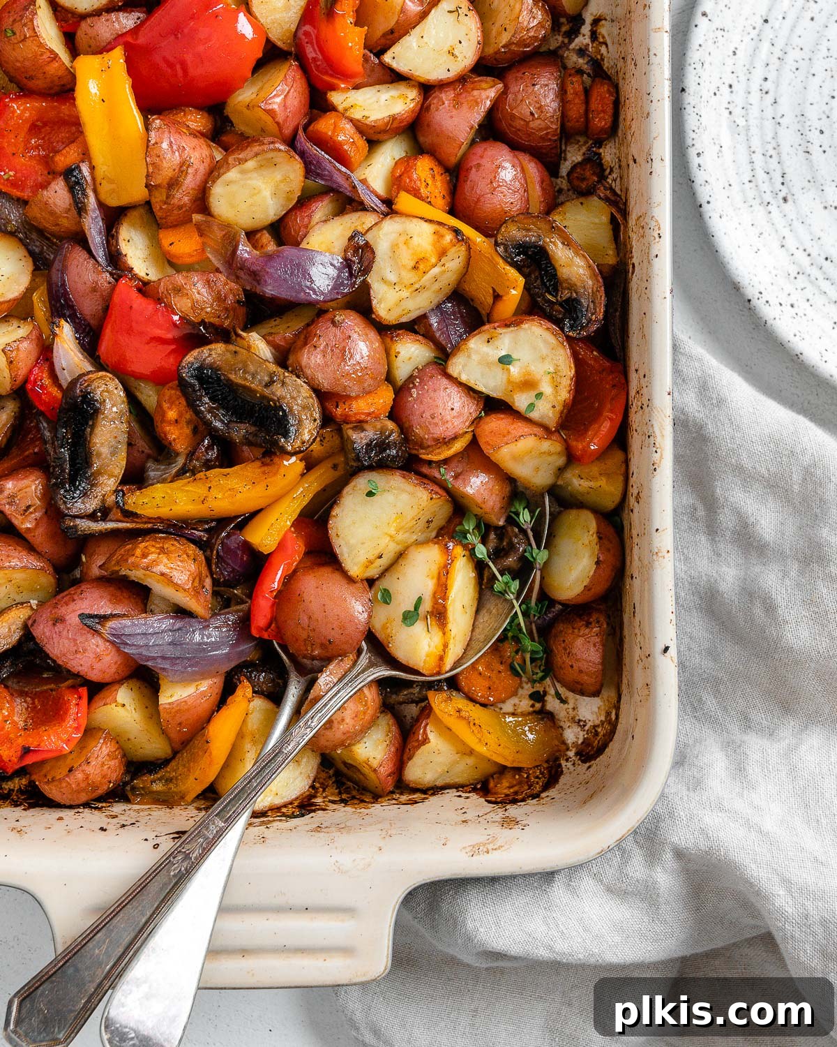 Thyme Kissed Roasted Vegan Medley 12 Close-up of completed Vegan Roasted Vegetables with Thyme in a baking dish, showcasing their golden-brown edges and tender texture.