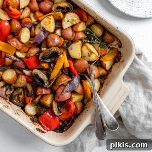 Thyme Kissed Roasted Vegan Medley 13 Completed Vegan Roasted Vegetables with Thyme in a baking dish against a white background.