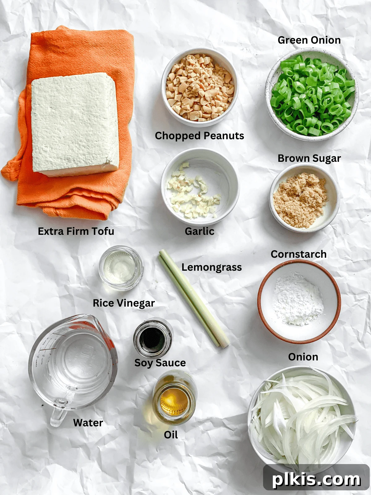 Vibrant Lemongrass Tofu 3 Ingredients for Lemongrass Tofu measured out on a white surface, showcasing fresh produce and pantry staples.