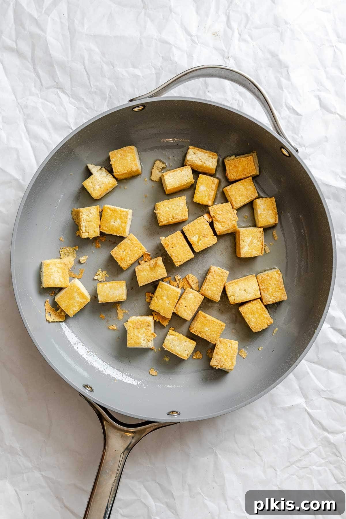 Vibrant Lemongrass Tofu 5 Process shot showing tofu cooking in a pan until golden brown.