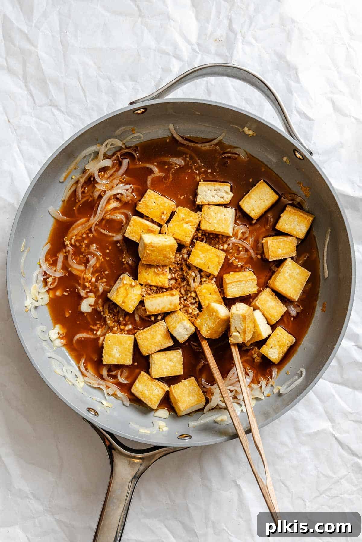 Vibrant Lemongrass Tofu 7 Process shot showing sauce added to pan with tofu, coating it evenly.