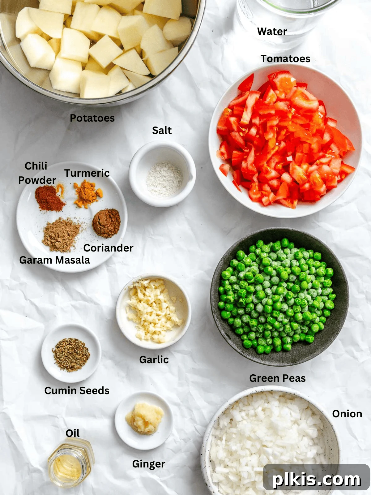 Spiced Potato & Pea Curry Made Simple 3 Ingredients for Easy Potato and Pea Curry (Aloo Matar) measured out on a white surface.