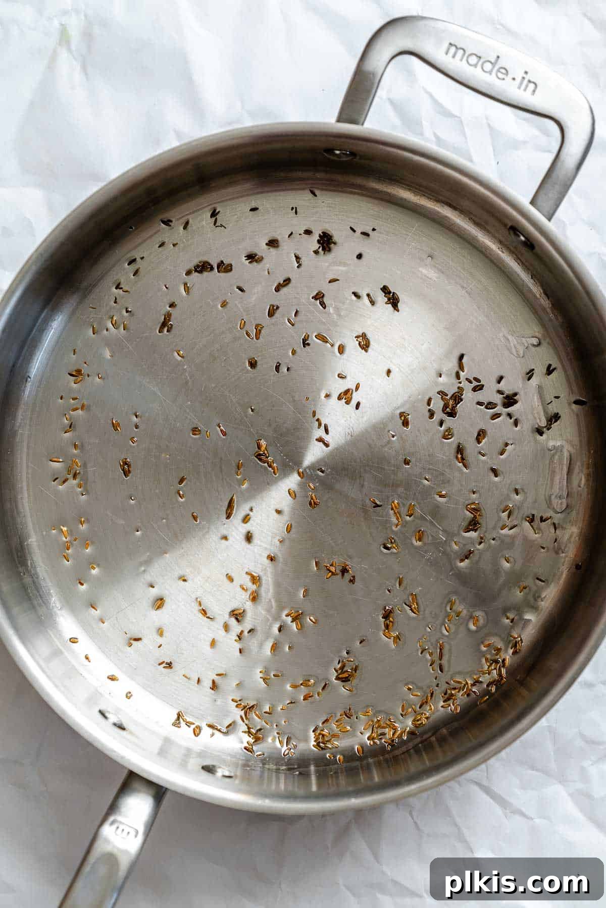 Spiced Potato & Pea Curry Made Simple 4 Process shot showing garlic cooking in pan.