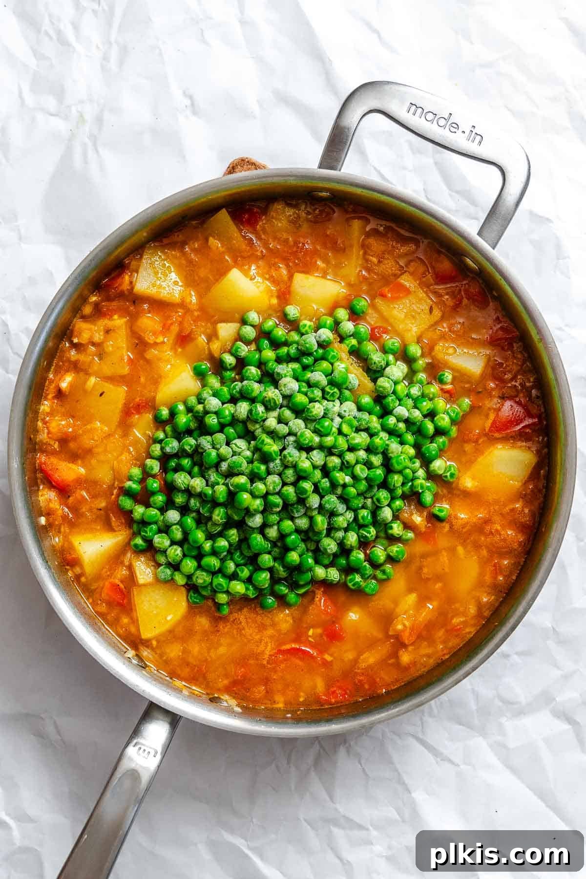 Spiced Potato & Pea Curry Made Simple 8 Process shot showing peas added to pot.