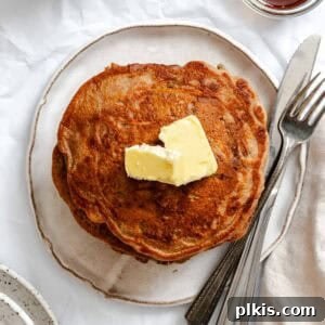 Completed stack of Carrot Cake Pancakes on a plate.
