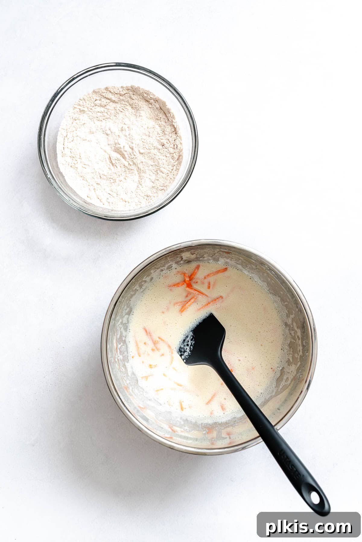 Spiced Carrot Cake Pancakes 6 Process shot showing mixing dry ingredients into wet ingredients.