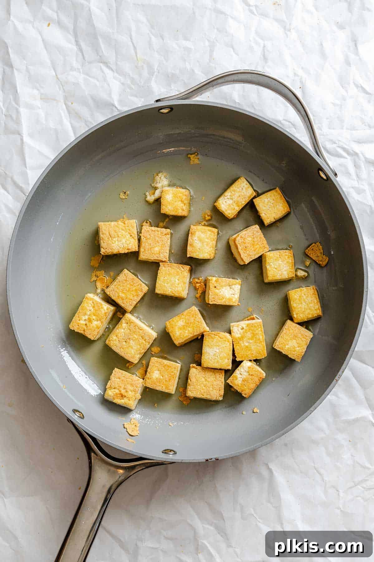 Zesty Lemon Glazed Tofu 5 Process shot showing tofu cooking on pan until golden brown and crispy.