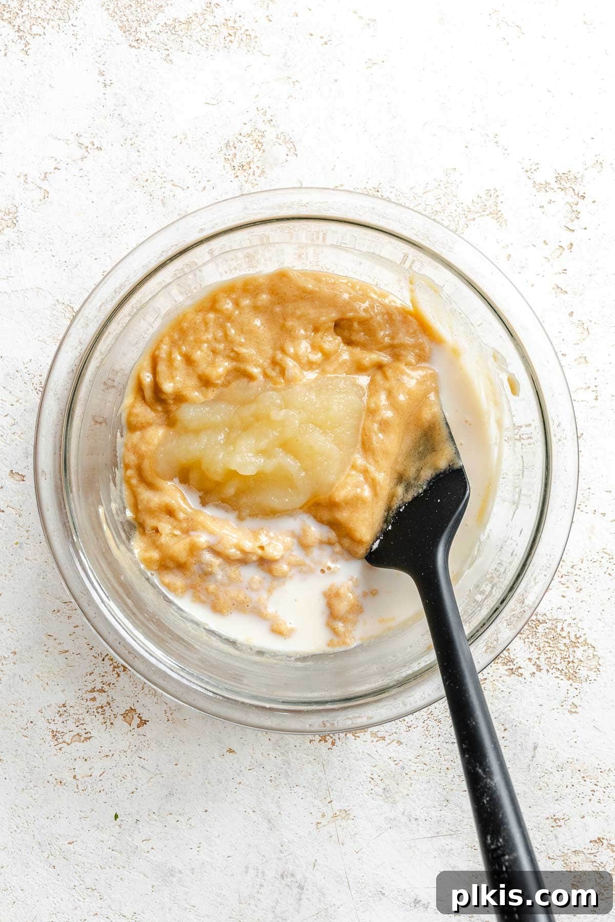 Rich Vegan Peanut Butter Bliss 5 Process shot showing mixing dry ingredients into wet ingredients in a bowl.