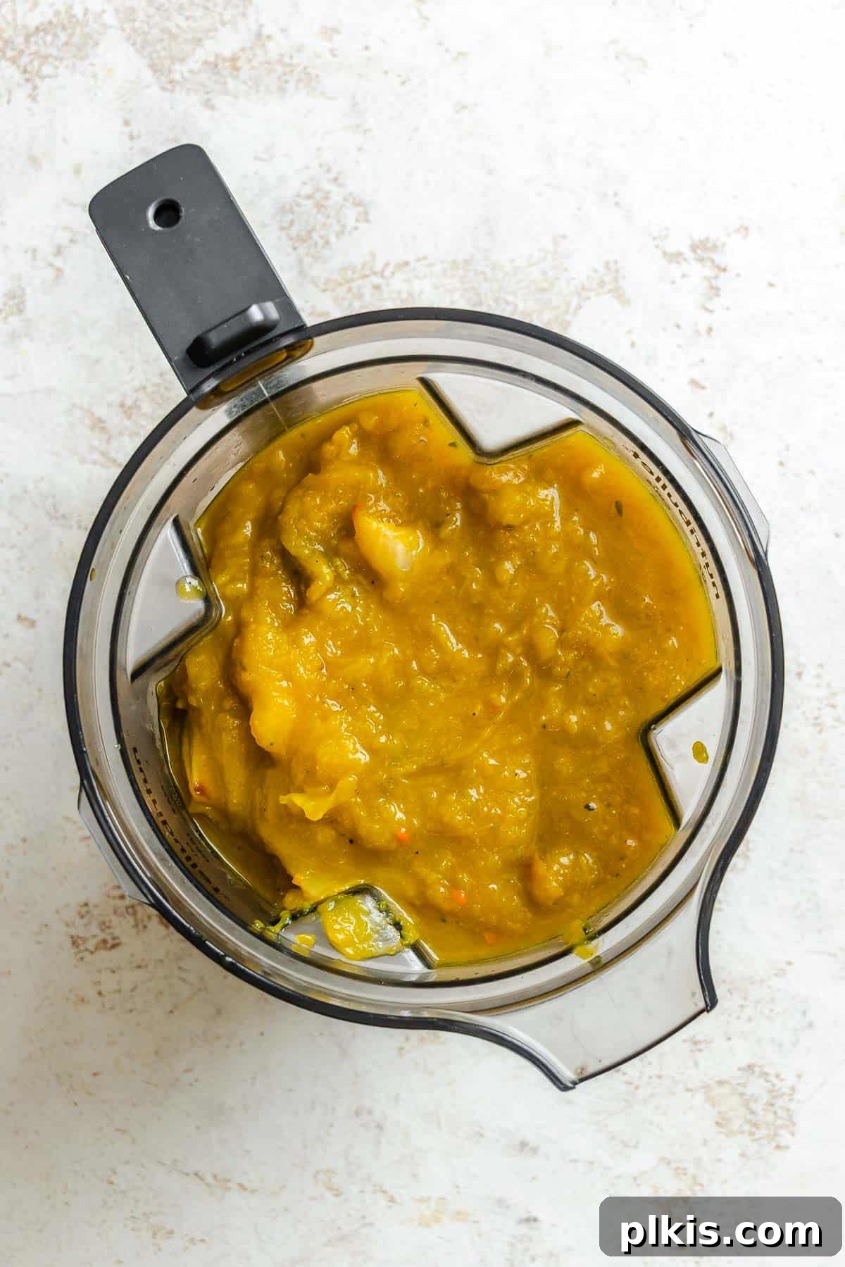 Velvety Golden Kabocha Soup 8 Process shot showing the simmering Kabocha Squash Soup ingredients being carefully poured into a blender for a smooth finish.