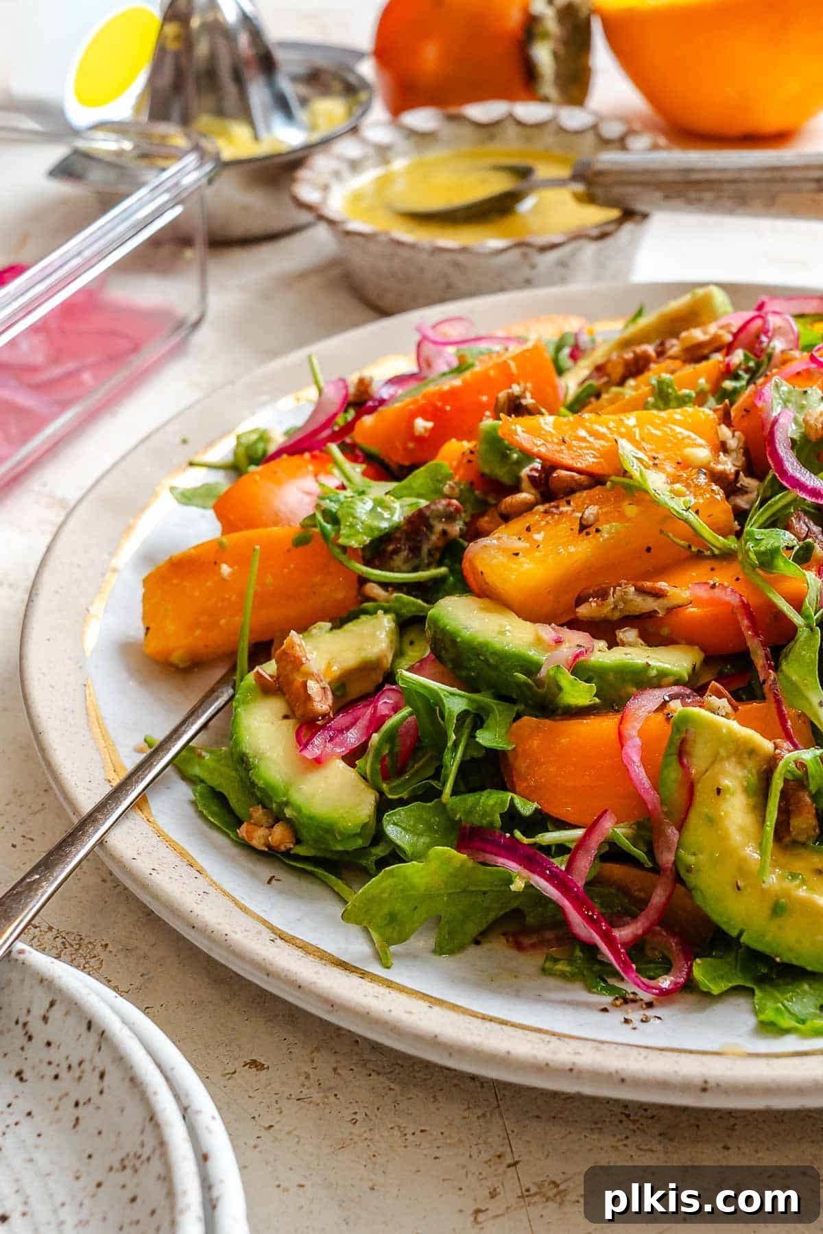 Golden Harvest Persimmon Salad 8 Completed Persimmon Salad on a plate. A close-up shot of the vibrant salad.