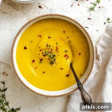 Hearty Quinoa and Vegetable Soup Recipe for Comforting Meals 11 Completed Kabocha Squash Soup in two bowls on a white surface.