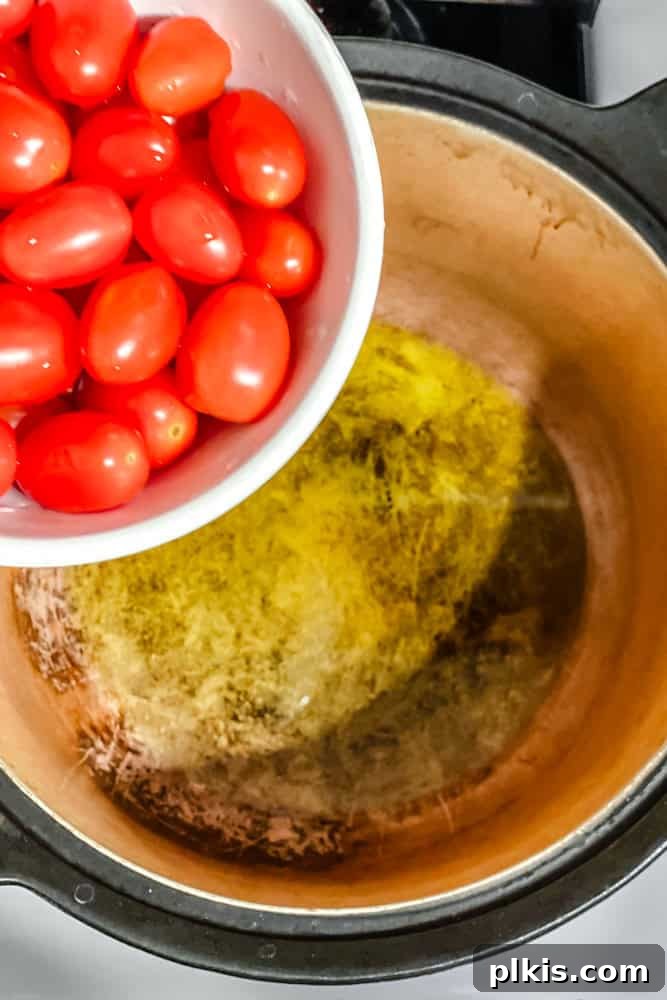 Hearty Quinoa and Vegetable Soup Recipe for Comforting Meals 4 process shot of adding tomatoes to pot