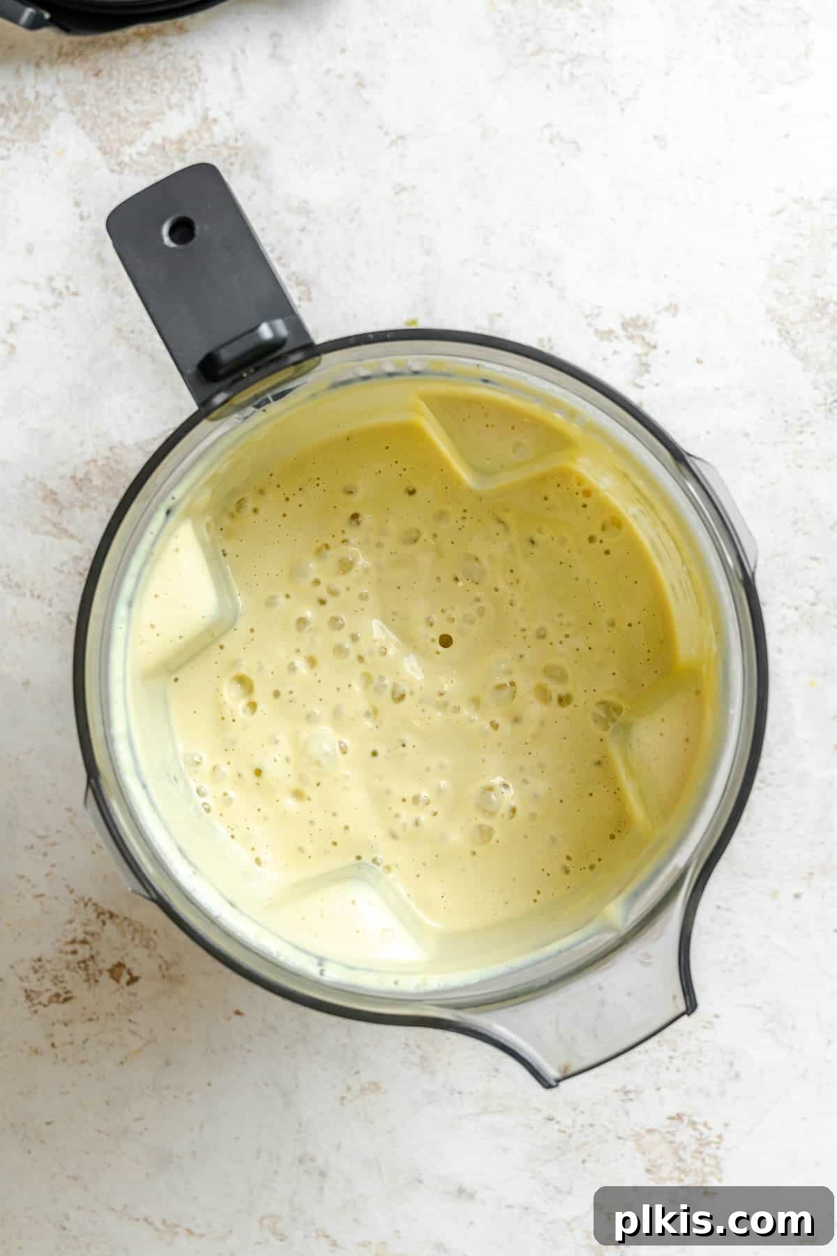 Creamy Vegan Cauliflower Alfredo Sauce Recipe 5 Process shot showing post blended ingredients in blender.