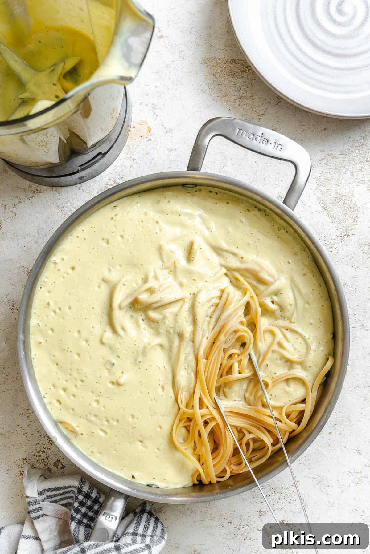 Creamy Vegan Cauliflower Alfredo Sauce Recipe 6 Process shot showing ingredients for Cauliflower Alfredo Sauce (Vegan) cooking in pot.