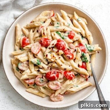 Creamy Vegan Cauliflower Alfredo Sauce Recipe 9 completed 20-Minute Creamy Tahini Pasta plated on a white plate against a light surface