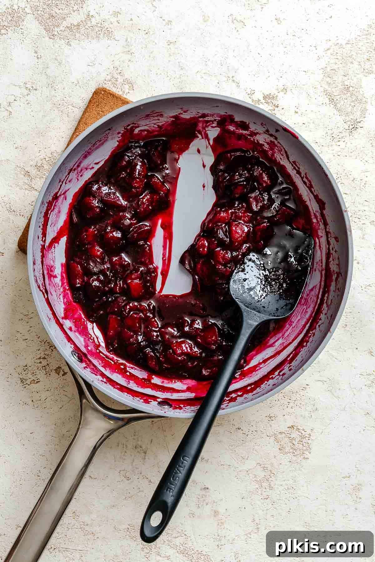 Homemade Plum Jam Without Pectin — Simple Stove-Top Recipe 5 Process shot showing mixing ingredients together in pan.