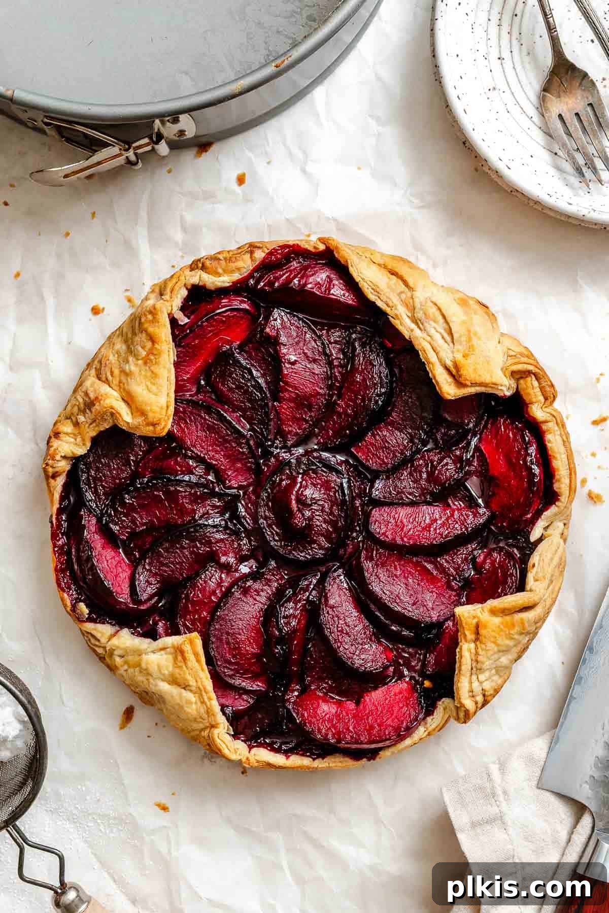 Classic Plum Galette Recipe: Homemade Rustic Tart with Fresh Plums 2 Completed Easy Plum Tart (Plum Galette) on a white surface.