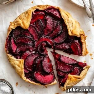 Classic Plum Galette Recipe: Homemade Rustic Tart with Fresh Plums 16 Completed Easy Plum Tart (Plum Galette) on a white surface.