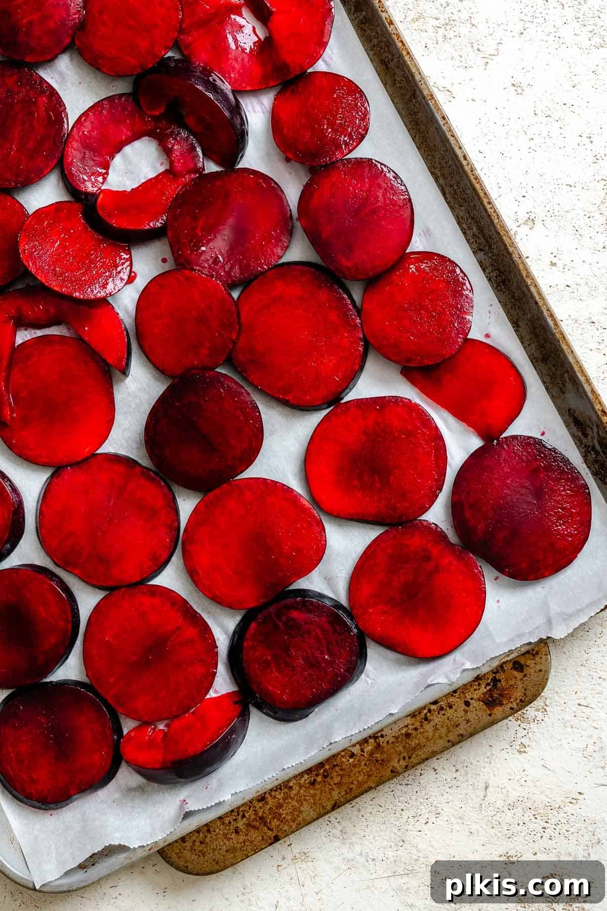 Classic Plum Galette Recipe: Homemade Rustic Tart with Fresh Plums 6 Process shot showing plums on baking sheet.