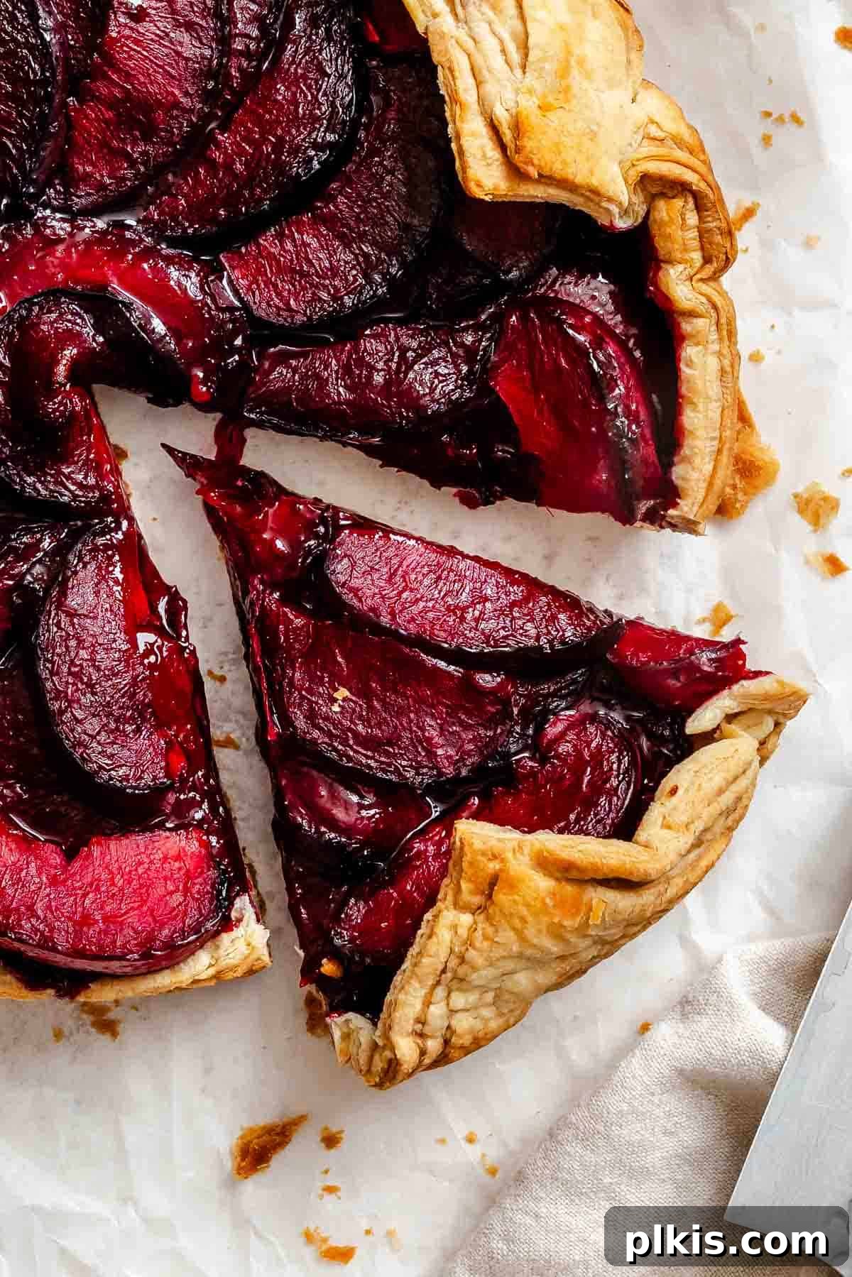 Classic Plum Galette Recipe: Homemade Rustic Tart with Fresh Plums 10 Completed Easy Plum Tart (Plum Galette) on a white surface.