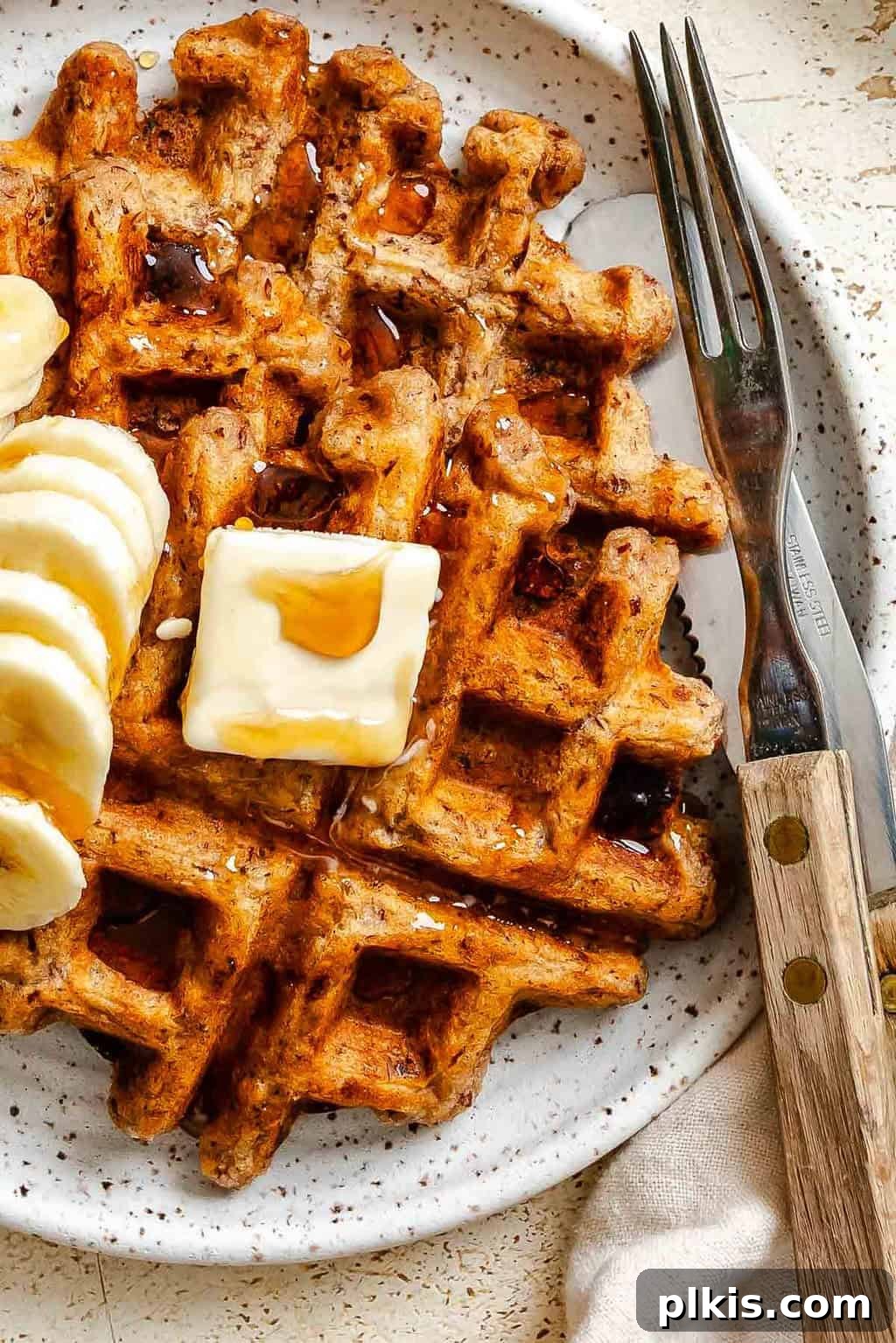 Crispy Vegan Banana Waffles with Maple Syrup Recipe 2 Completed Vegan Banana Waffles on a plate.
