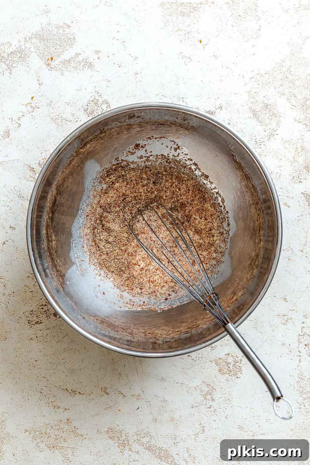 Crispy Vegan Banana Waffles with Maple Syrup Recipe 4 Process shot showing whisking ingredients in a bowl.