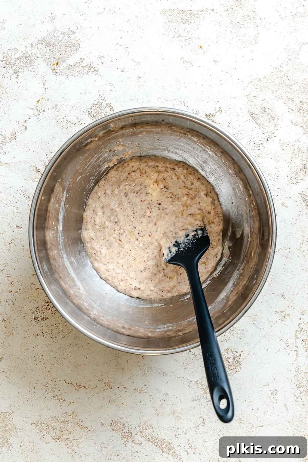 Crispy Vegan Banana Waffles with Maple Syrup Recipe 6 Process shot showing stirring ingredients in a bowl.