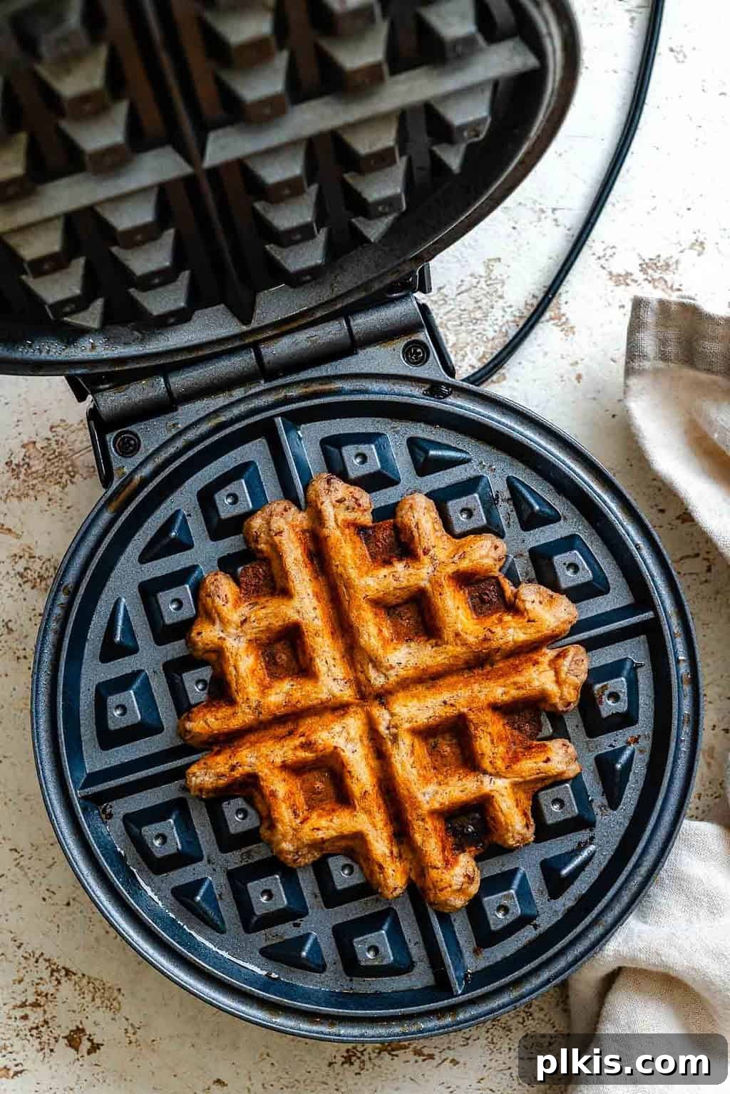 Crispy Vegan Banana Waffles with Maple Syrup Recipe 7 Process shot showing waffle cooking in waffle maker.