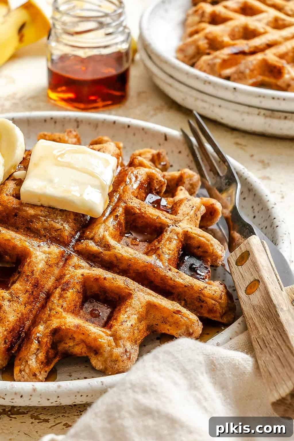 Crispy Vegan Banana Waffles with Maple Syrup Recipe 8 Completed Vegan Banana Waffles on a plate.