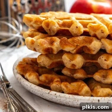 Crispy Vegan Banana Waffles with Maple Syrup Recipe 10 Completed Apple Cinnamon Waffles (Eggless) stacked on a plate.
