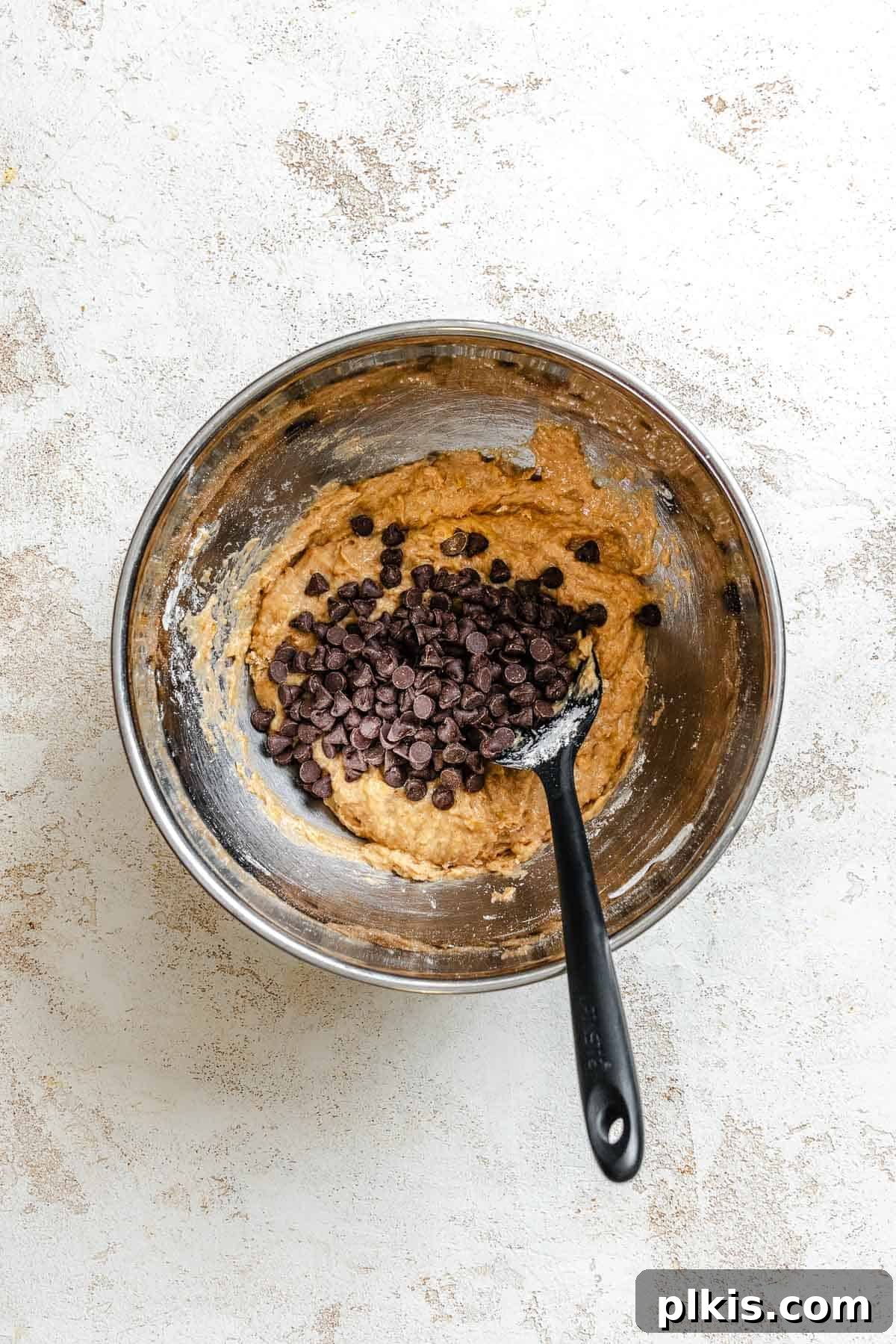 Soft Chewy Banana Bread Cookies Recipe 6 Process shots showing adding vegan chocolate chips into bowl.