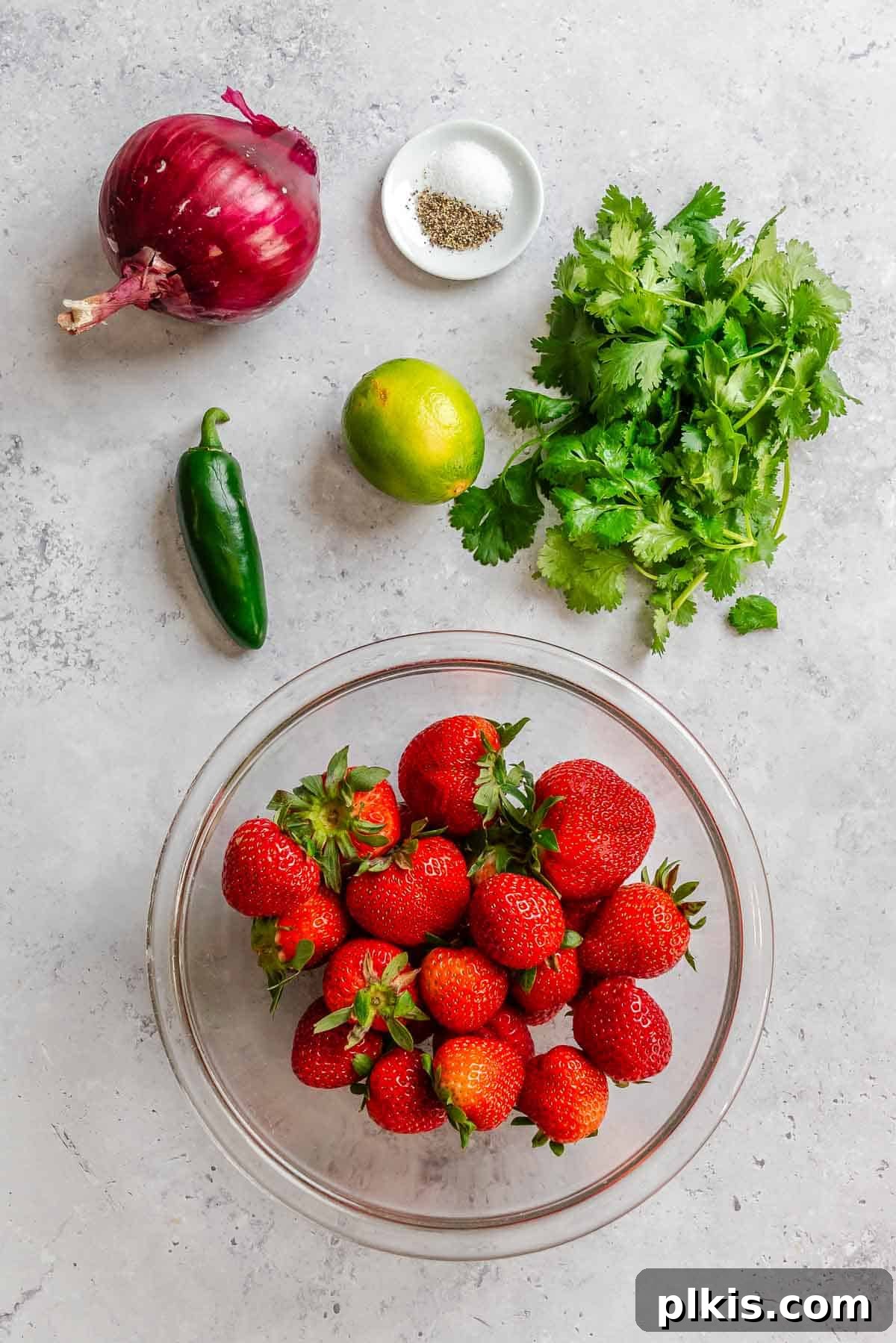 Fresh Strawberry Salsa: Sweet, Tangy Summer Recipe 5 Ingredients for strawberry salsa measured out on a white surface.