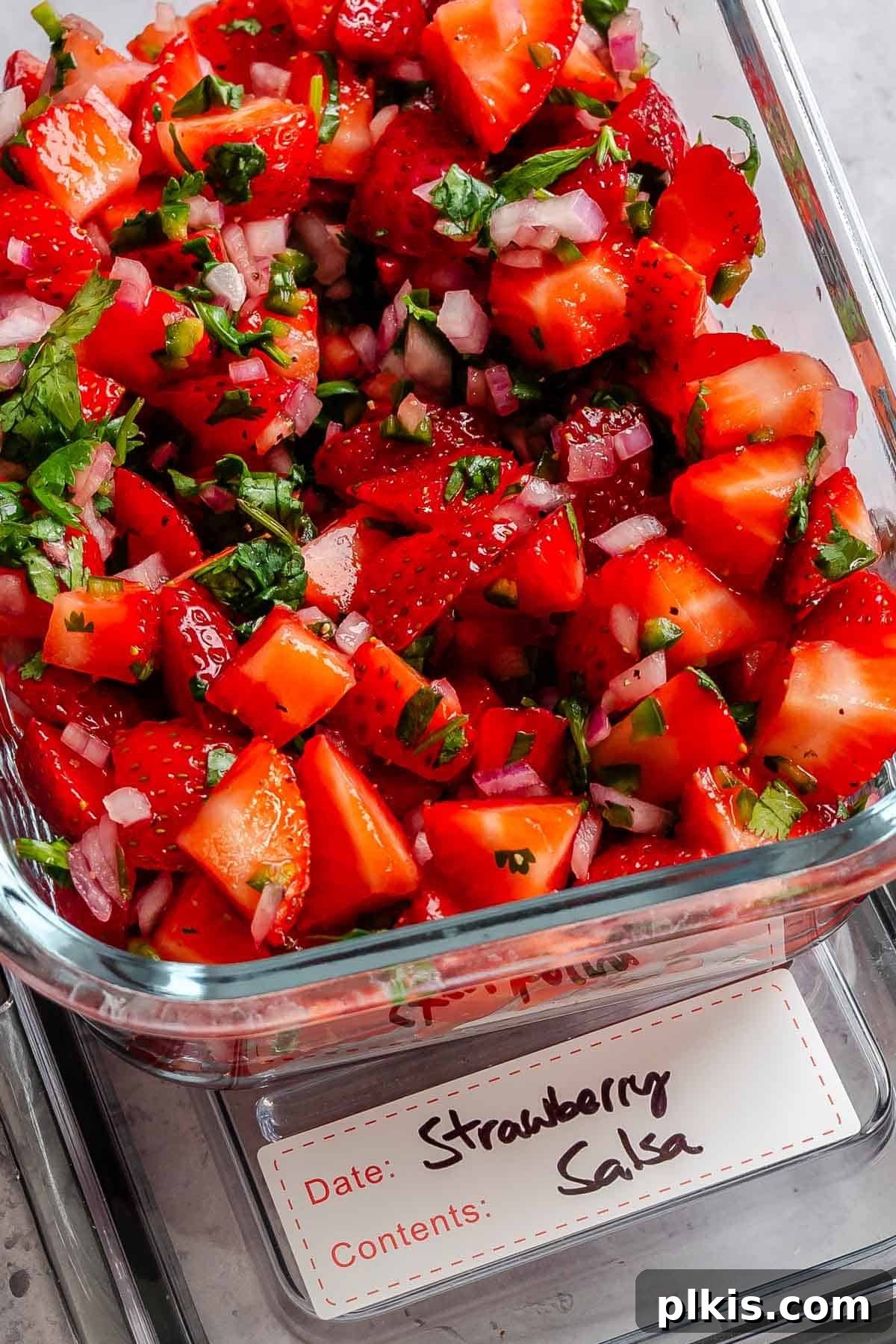 Fresh Strawberry Salsa: Sweet, Tangy Summer Recipe 9 Completed strawberry salsa in a storage container.