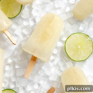 Homemade Zesty Lime Popsicles Recipe 13 Several completed Easy Lime Popsicles on a white surface.