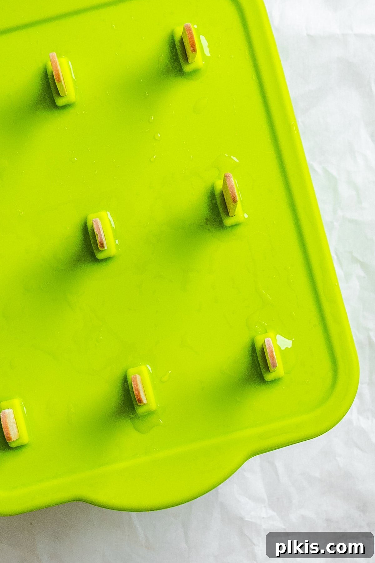 Homemade Zesty Lime Popsicles Recipe 8 Several completed Easy Lime Popsicles in popsicle mold.