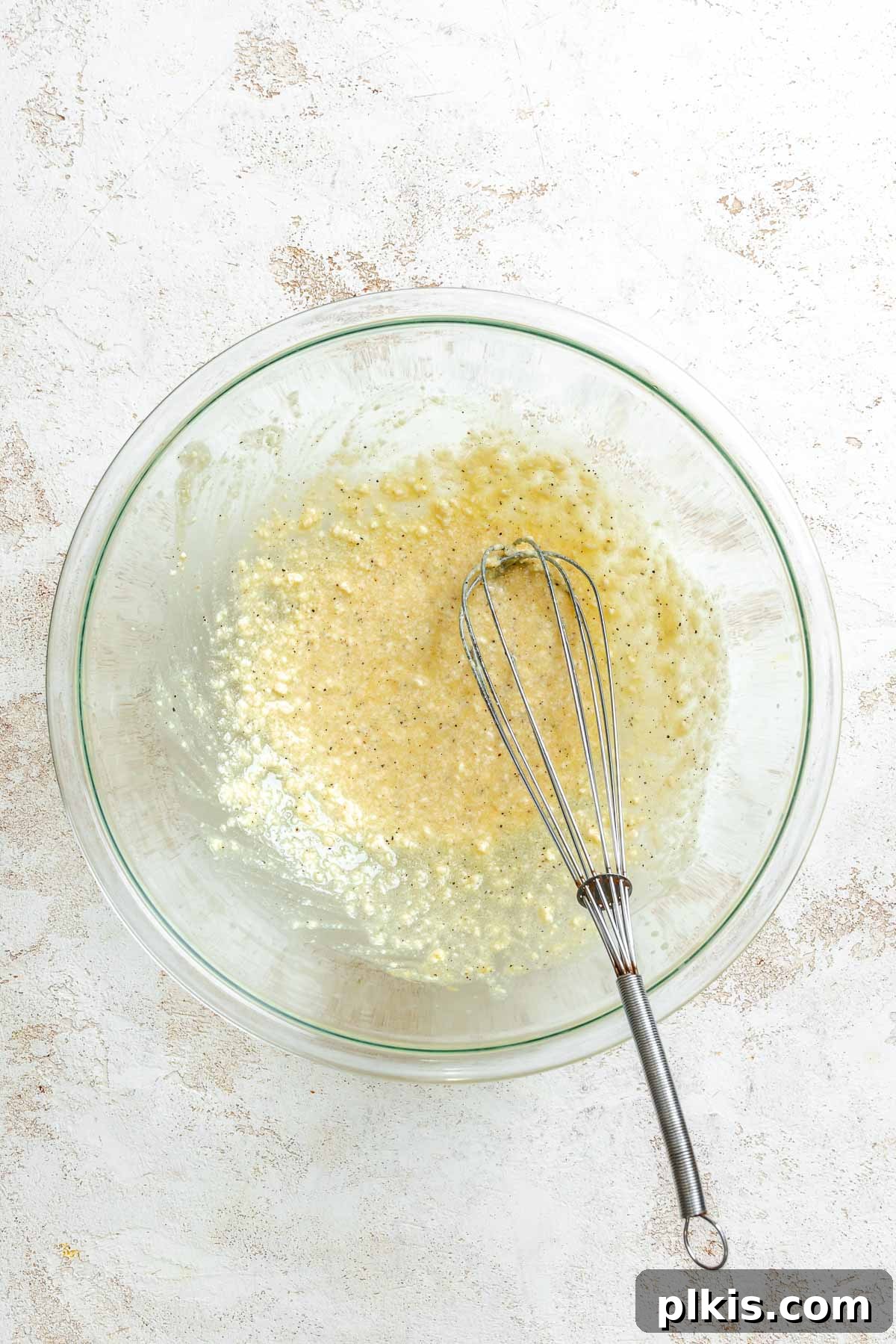 Roasted Cauliflower Salad with Lemon & Herbs 4 Process shot showing whisking ingredients together in a bowl.