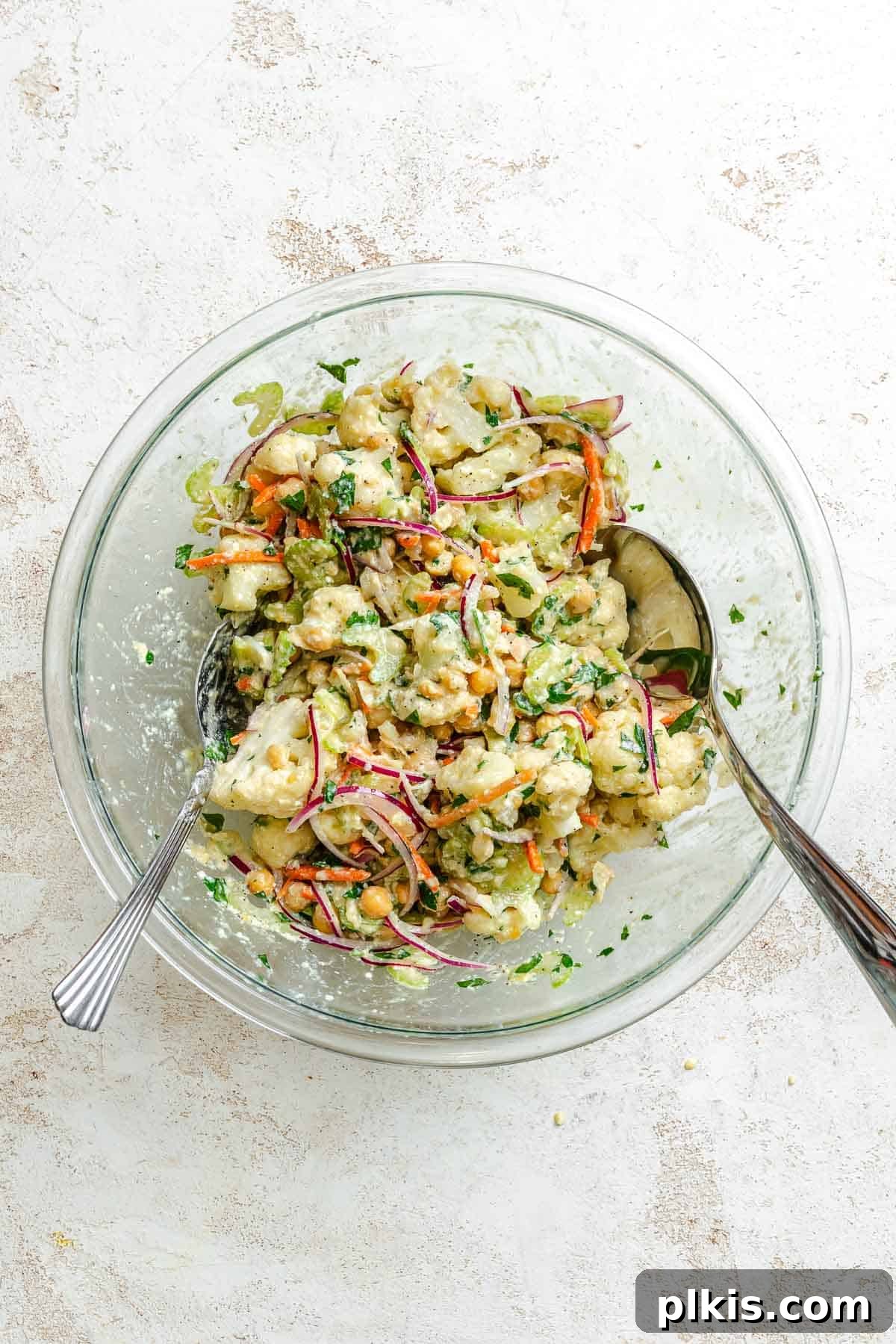 Roasted Cauliflower Salad with Lemon & Herbs 5 Process shot showing mixing ingredients together in a bowl.
