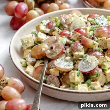 Roasted Cauliflower Salad with Lemon & Herbs 8 completed Vegan Chicken and California Grape Salad on a plate