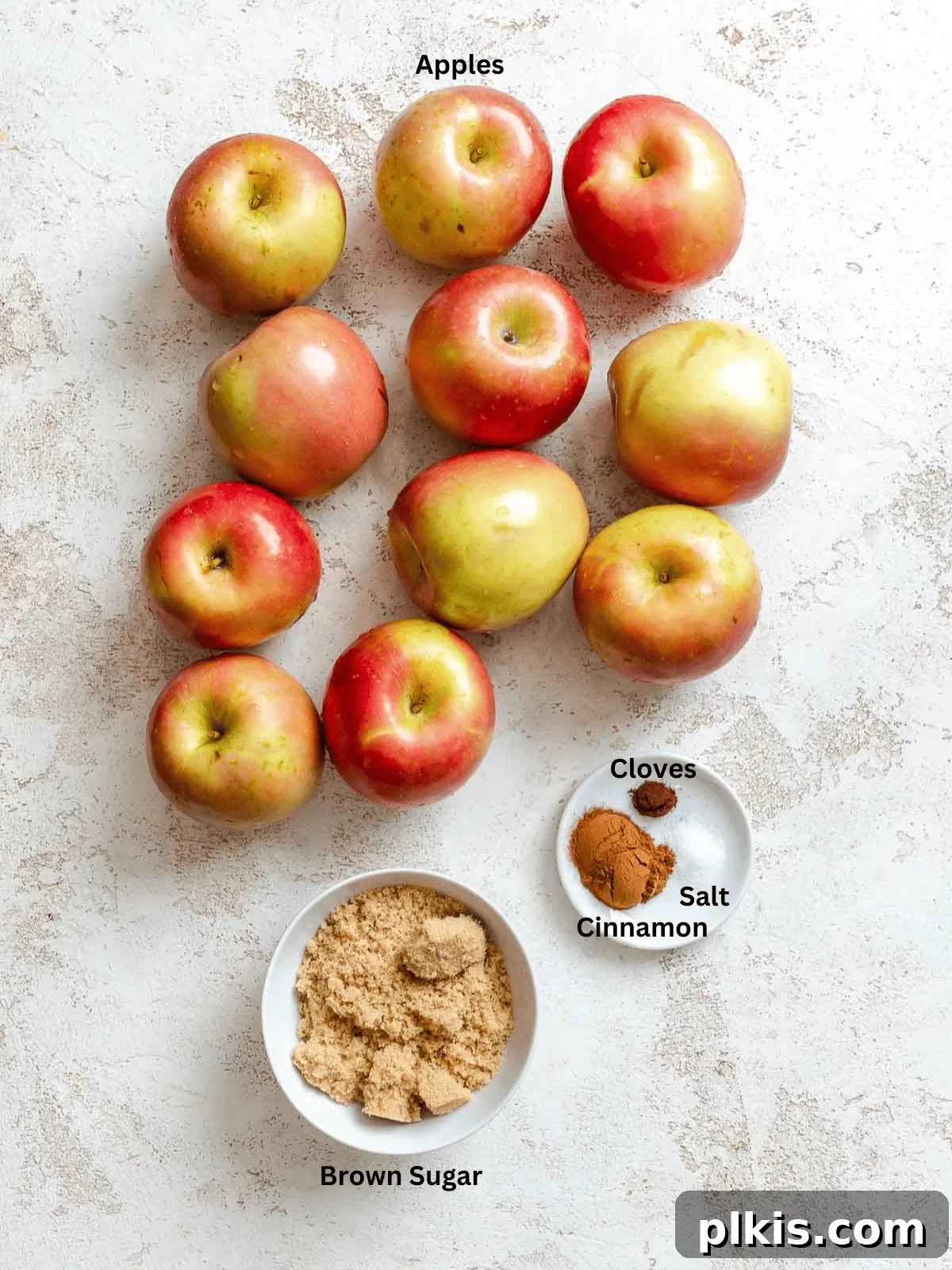 Ingredients for Instant Pot Apple Butter measured out on a white surface.